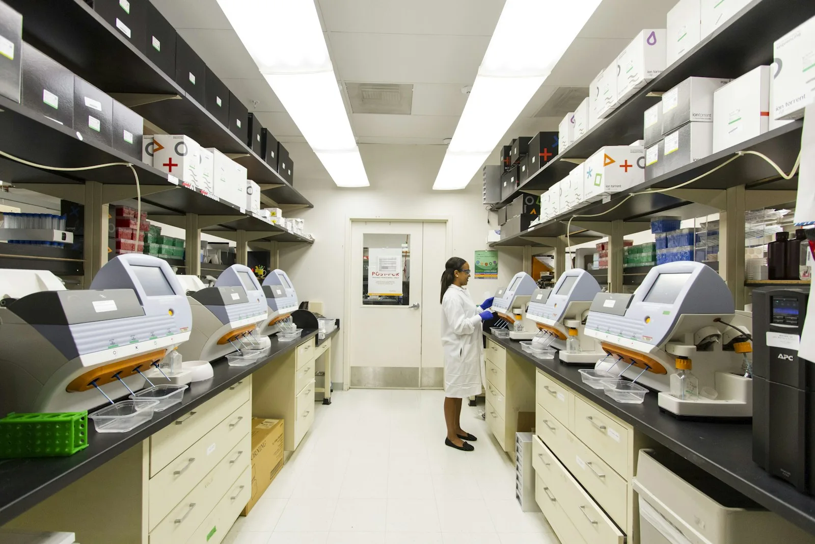Laboratory professional working among diagnostic instruments